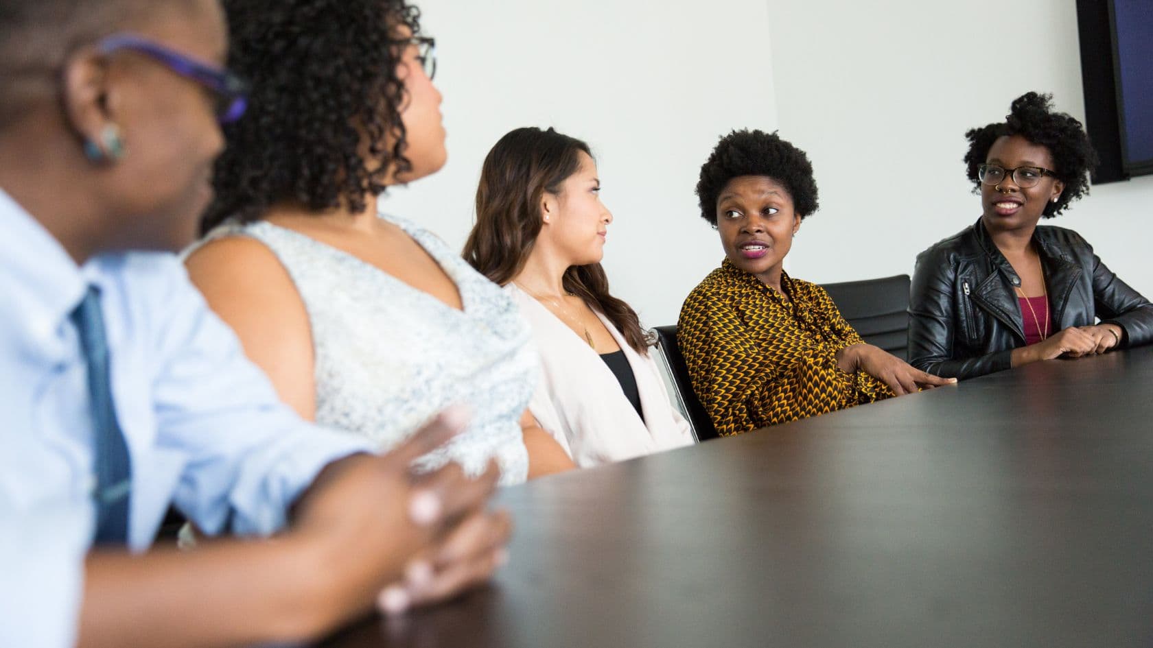 Community partners and organizers meeting around a table in a shared workspace.