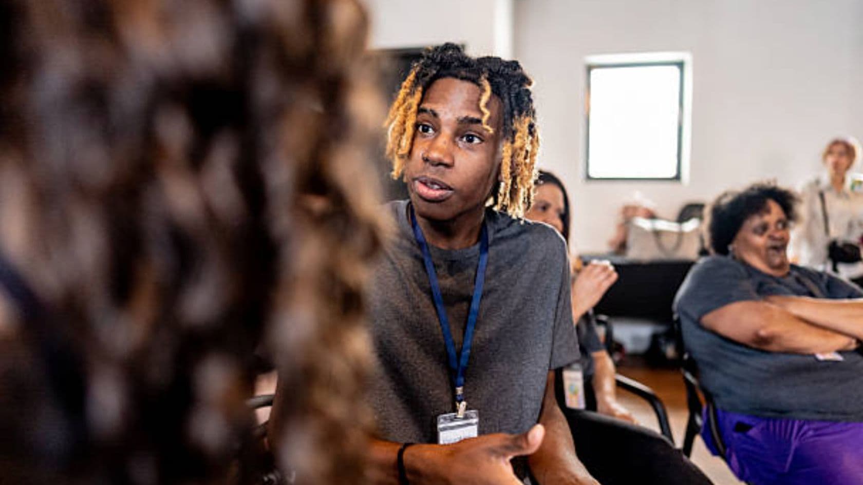 A peer facilitator speaking with community members during a WellXcel session.